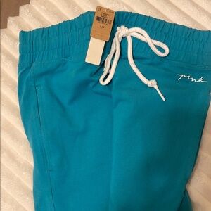 Teal Skinny Jogger Pants with White Drawstring and White Pink Logo. High Waisted